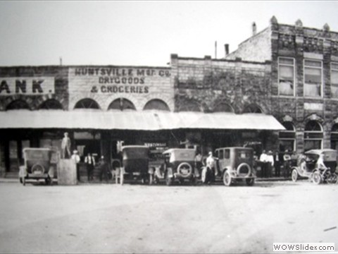 Farmers and Merchants Bank; Huntsville Mercantile Co.; Drug Store, Post Office; First National Bank.